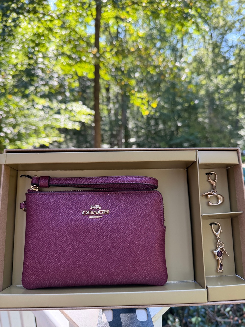 Coach Burgundy 3 piece box set Metallic wristlet with gold accents and 2 charms